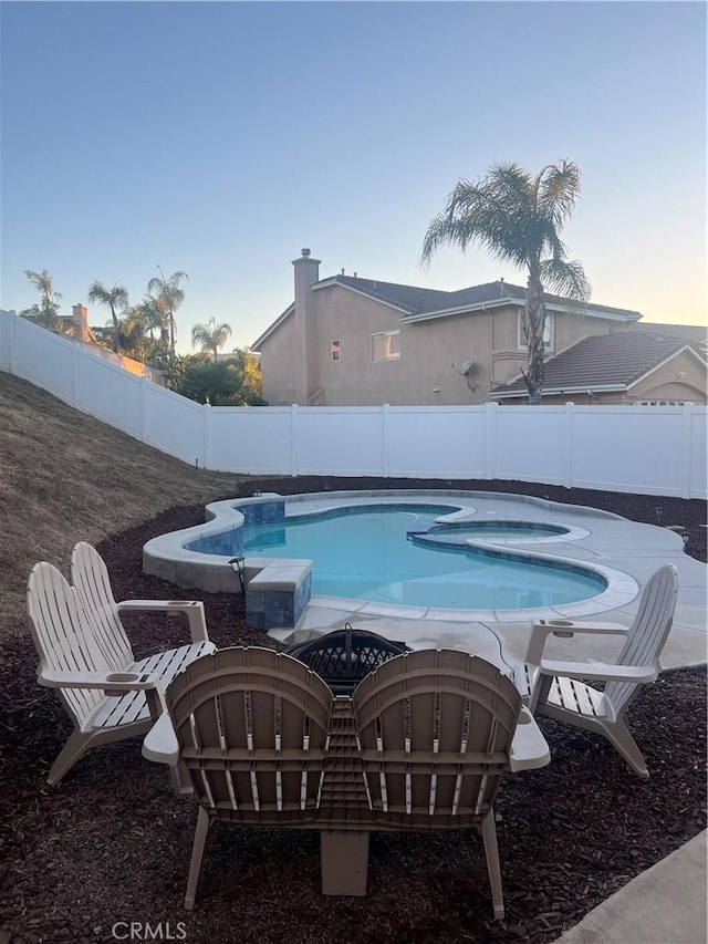 2775 Canyon View Cir, Corona, CA 92882 - pool at dusk featuring a fenced backyard and an in-ground hot tub
