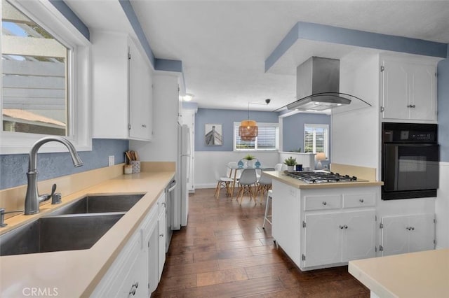 3144 W 154th Pl, Gardena, CA 90249 - kitchen featuring black oven, island exhaust hood, stainless steel gas cooktop, and white cabinetry