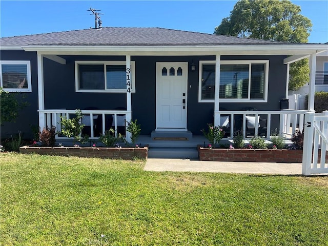 3144 W 154th Pl, Gardena, CA 90249 - view of front of property with a porch, a front lawn, roof with shingles, and stucco siding