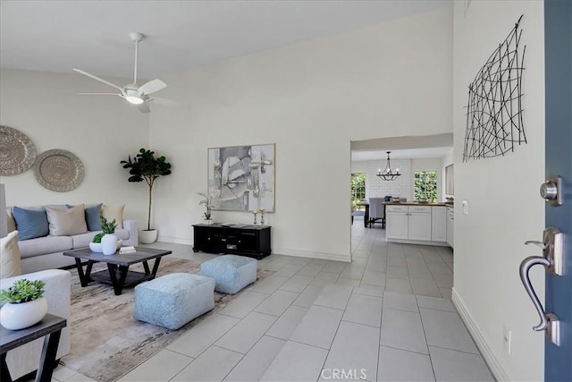 124 Marion Blvd, Fullerton, CA 92835 - tiled living room featuring high vaulted ceiling, a chandelier, and a ceiling fan
