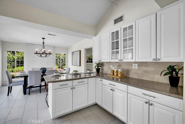 124 Marion Blvd, Fullerton, CA 92835 - kitchen featuring a peninsula, white cabinetry, healthy amount of natural light, and lofted ceiling