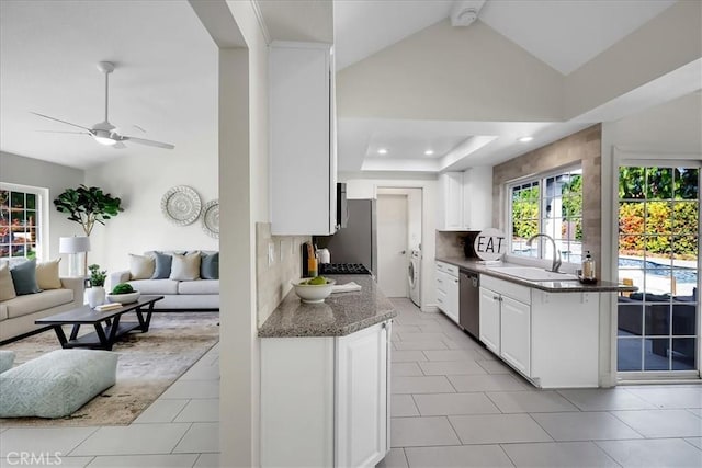 124 Marion Blvd, Fullerton, CA 92835 - kitchen with dishwasher, open floor plan, washer / dryer, a ceiling fan, and backsplash