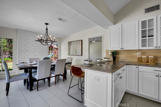 124 Marion Blvd, Fullerton, CA 92835 - kitchen with a peninsula, white cabinets, glass insert cabinets, tasteful backsplash, and a chandelier