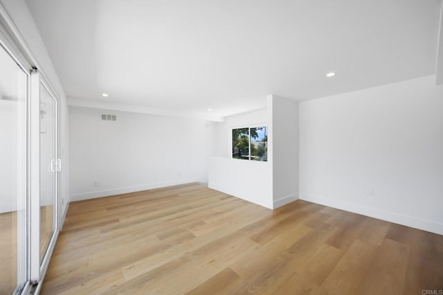 11741 Foster Rd, Los Alamitos, CA 90720 - empty room with recessed lighting and light wood finished floors