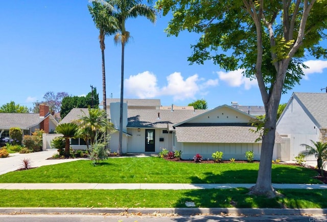 11741 Foster Rd, Los Alamitos, CA 90720 - view of front of home with roof with shingles, a front yard, and driveway