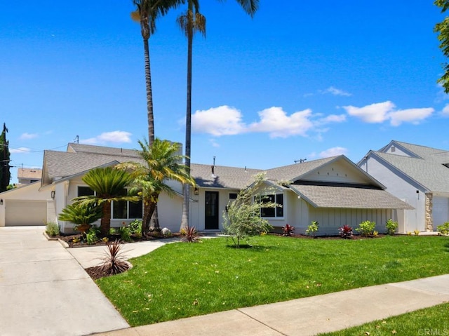 11741 Foster Rd, Los Alamitos, CA 90720 - single story home featuring driveway, a front lawn, a shingled roof, and board and batten siding