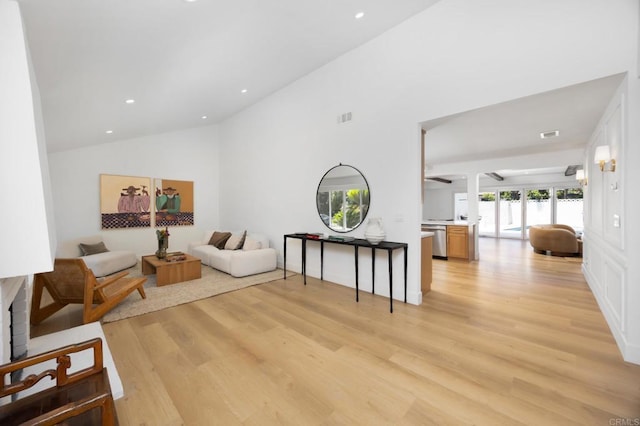 11741 Foster Rd, Los Alamitos, CA 90720 - living area featuring light wood-style flooring, recessed lighting, high vaulted ceiling, and a ceiling fan