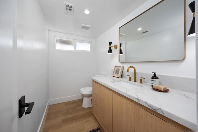 11741 Foster Rd, Los Alamitos, CA 90720 - bathroom with vanity, wood finished floors, and recessed lighting