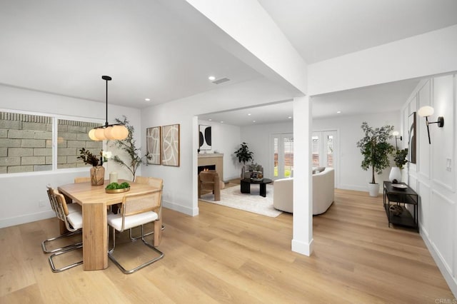 19222 S Grandee Ave, Carson, CA 90746 - dining area with light wood-style flooring, a lit fireplace, and recessed lighting