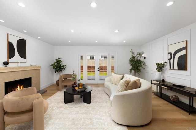 19222 S Grandee Ave, Carson, CA 90746 - living room with french doors, light wood finished floors, recessed lighting, and a high end fireplace