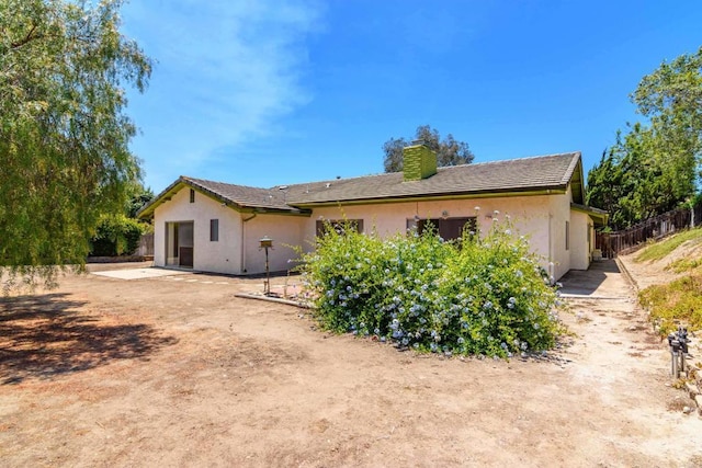 10665 Loire Ave, San Diego, CA 92131 - rear view of property with stucco siding and a chimney