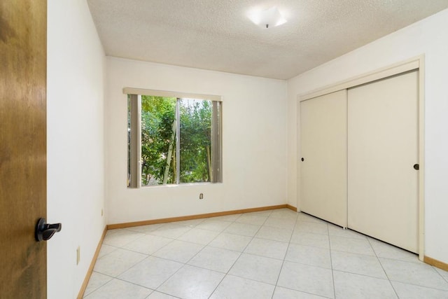 10665 Loire Ave, San Diego, CA 92131 - unfurnished bedroom with a textured ceiling and a closet