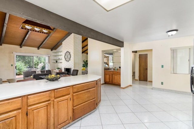 10665 Loire Ave, San Diego, CA 92131 - kitchen with light countertops, a brick fireplace, light tile patterned flooring, open floor plan, and wood ceiling
