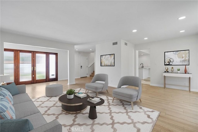 20 Mayapple Way, Irvine, CA 92612 - living room with light wood-type flooring, french doors, recessed lighting, and stairs