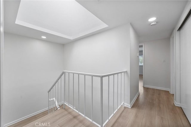 20 Mayapple Way, Irvine, CA 92612 - hallway with an upstairs landing, wood finished floors, recessed lighting, and a tray ceiling