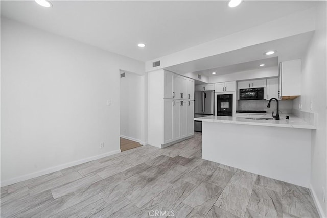 20 Mayapple Way, Irvine, CA 92612 - kitchen with light countertops, recessed lighting, black oven, white cabinets, and a peninsula