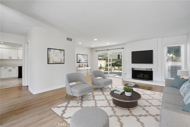 20 Mayapple Way, Irvine, CA 92612 - living room featuring light wood-style floors, a fireplace, and recessed lighting