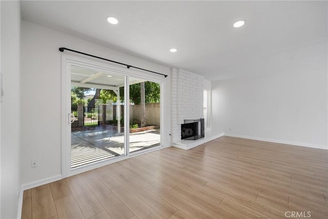 20 Mayapple Way, Irvine, CA 92612 - unfurnished living room featuring light wood finished floors, a brick fireplace, and recessed lighting