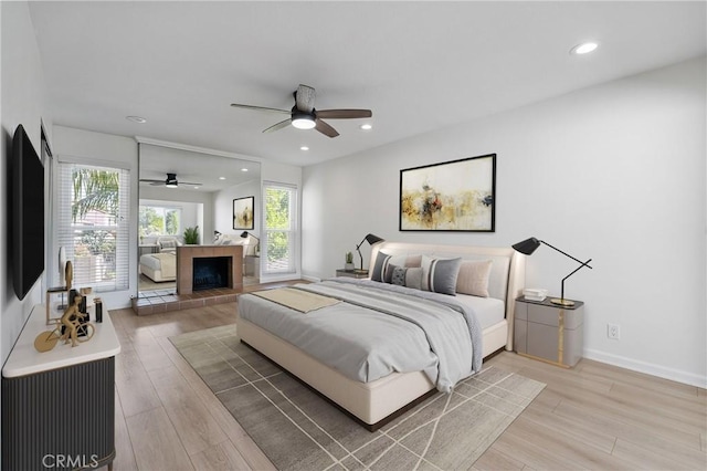 20 Mayapple Way, Irvine, CA 92612 - bedroom with light wood-style flooring, recessed lighting, a ceiling fan, and a tile fireplace