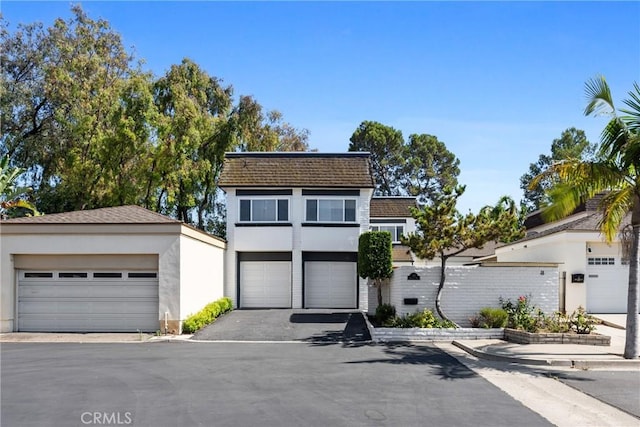20 Mayapple Way, Irvine, CA 92612 - view of front of home with stucco siding, a garage, and an outbuilding
