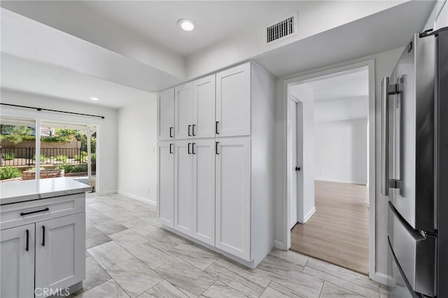 20 Mayapple Way, Irvine, CA 92612 - kitchen featuring freestanding refrigerator, white cabinetry, light countertops, a barn door, and recessed lighting
