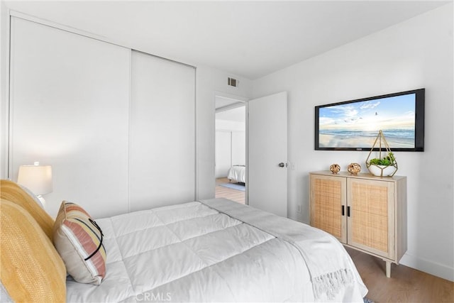 21951 Rimhurst Dr Unit F201, Lake Forest, CA 92630 - bedroom featuring wood finished floors and a closet