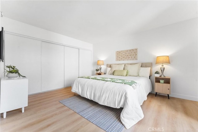 21951 Rimhurst Dr Unit F201, Lake Forest, CA 92630 - bedroom featuring light wood finished floors and a closet