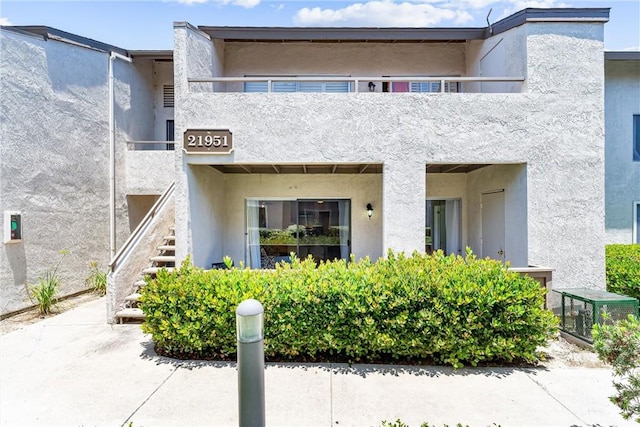 21951 Rimhurst Dr Unit F201, Lake Forest, CA 92630 - rear view of property with stairway, stucco siding, and a balcony