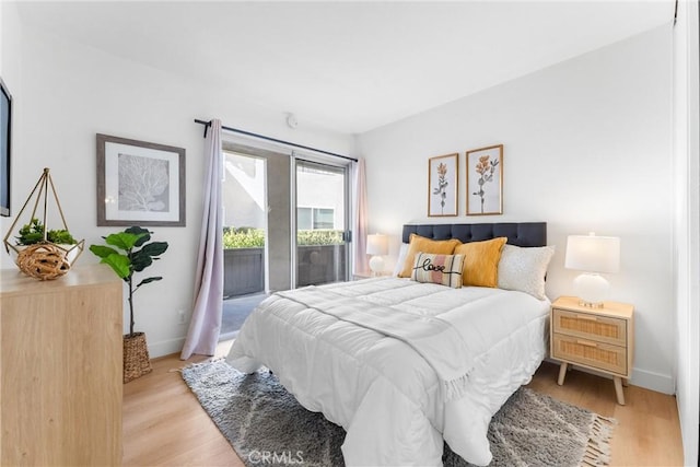 21951 Rimhurst Dr Unit F201, Lake Forest, CA 92630 - bedroom featuring access to exterior and light wood finished floors