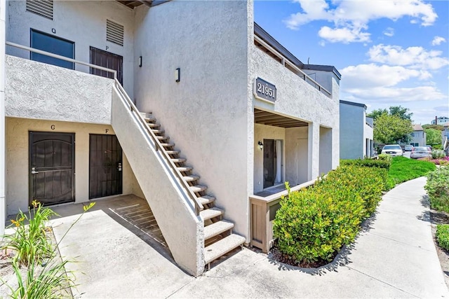 21951 Rimhurst Dr Unit F201, Lake Forest, CA 92630 - view of side of property with stairway and stucco siding