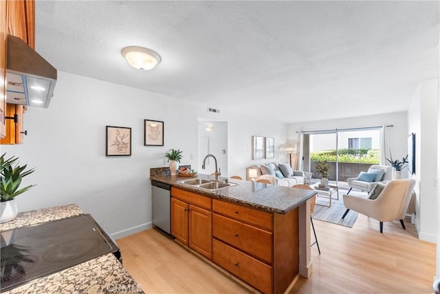21951 Rimhurst Dr Unit F201, Lake Forest, CA 92630 - kitchen with a peninsula, dishwasher, brown cabinetry, light wood-style flooring, and range with electric stovetop