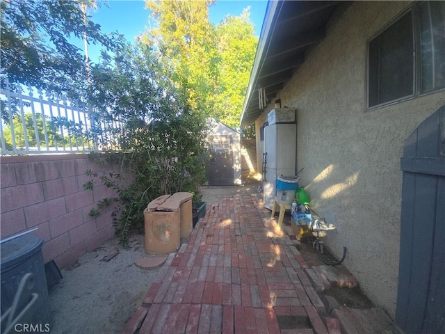 8450 Limerick Ave, Winnetka, CA 91306 - view of side of home with stucco siding and a patio area