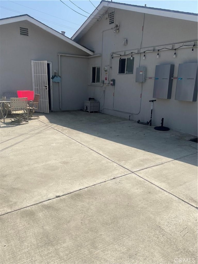 26832 6th St, Highland, CA 92346 - rear view of house with stucco siding and a patio
