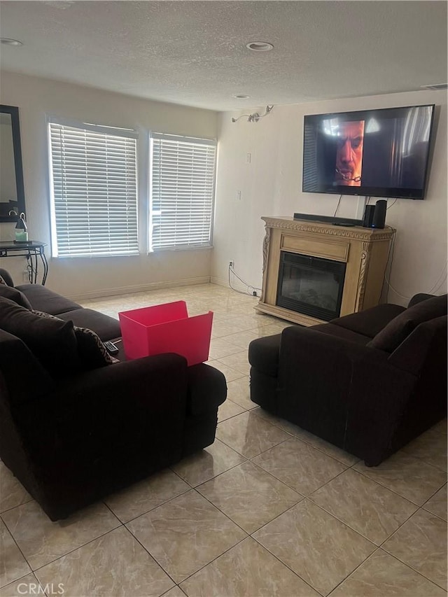 26832 6th St, Highland, CA 92346 - living area featuring a textured ceiling, tile patterned floors, and a glass covered fireplace