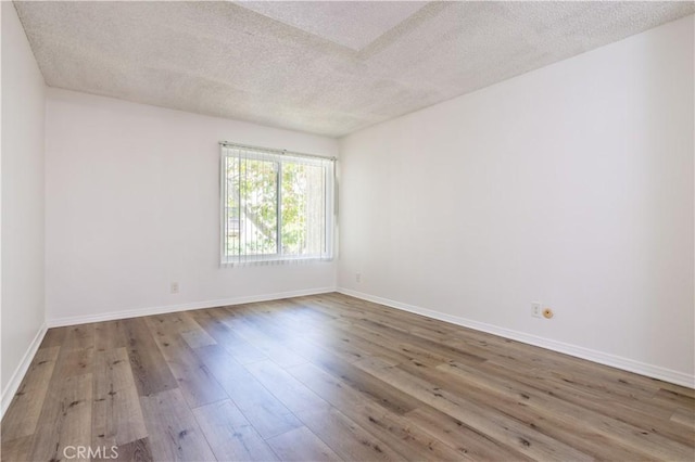 7205 Summertime Ln, Culver City, CA 90230 - empty room with a textured ceiling and hardwood / wood-style floors