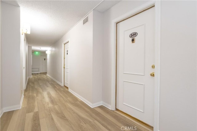 7205 Summertime Ln, Culver City, CA 90230 - corridor featuring light wood finished floors and a textured ceiling