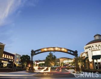 29 Quartz Ln, Ladera Ranch, CA 92694 - view of asphalt road featuring a gate, curbs, and sidewalks