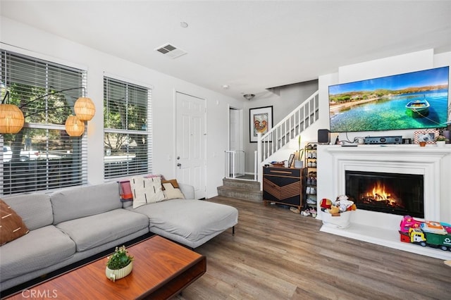 29 Quartz Ln, Ladera Ranch, CA 92694 - living area featuring wood finished floors, stairway, and a glass covered fireplace