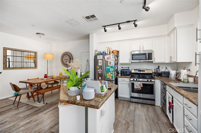 29 Quartz Ln, Ladera Ranch, CA 92694 - kitchen featuring stainless steel appliances, light wood-type flooring, white cabinetry, and dark stone countertops