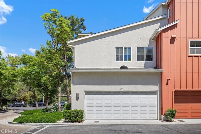 29 Quartz Ln, Ladera Ranch, CA 92694 - view of side of home featuring board and batten siding and an attached garage