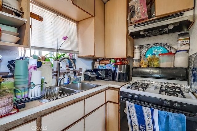 1270 S Hicks Ave, Los Angeles, CA 90023 - kitchen featuring black gas stove, light countertops, white cabinetry, and exhaust hood