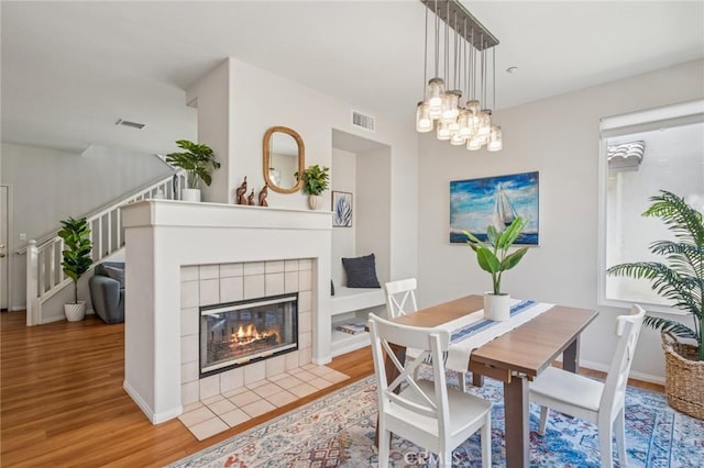 1757 Pierce Ln, Placentia, CA 92870 - dining space featuring wood finished floors, stairs, a chandelier, and a fireplace