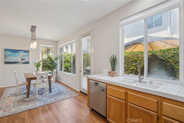 1757 Pierce Ln, Placentia, CA 92870 - kitchen with stainless steel dishwasher, light wood-type flooring, decorative light fixtures, and brown cabinets