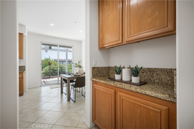 420 Augusta Ln, Placentia, CA 92870 - kitchen with light tile patterned flooring, light stone countertops, brown cabinets, and recessed lighting