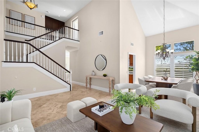 61 Clermont, Newport Coast, CA 92657 - living area with a high ceiling, a chandelier, stairs, and plenty of natural light