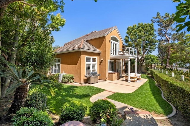 61 Clermont, Newport Coast, CA 92657 - back of house with a balcony, stucco siding, a tiled roof, and a patio