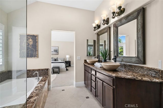 61 Clermont, Newport Coast, CA 92657 - ensuite bathroom featuring double vanity, a garden tub, and plenty of natural light