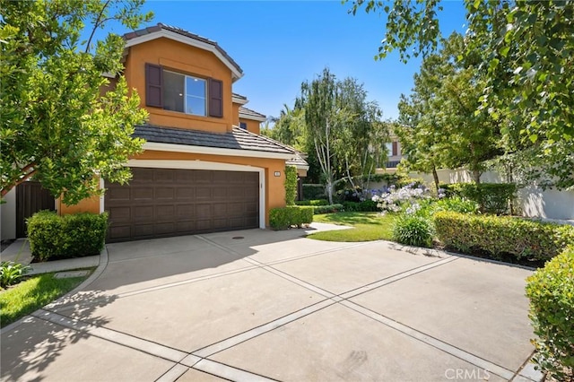 61 Clermont, Newport Coast, CA 92657 - view of front of property with stucco siding, a tiled roof, an attached garage, and concrete driveway