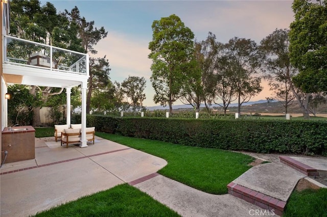 61 Clermont, Newport Coast, CA 92657 - yard at dusk featuring a patio, a lawn, and a balcony
