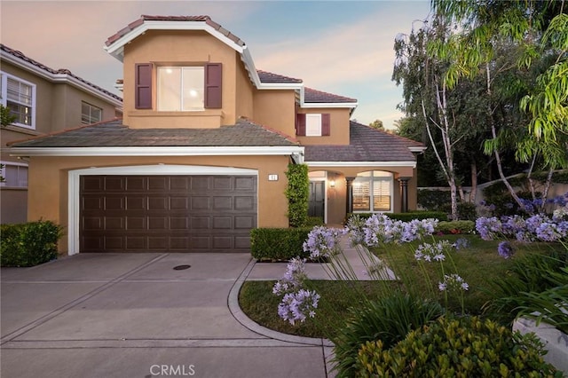 61 Clermont, Newport Coast, CA 92657 - view of front of home with stucco siding, concrete driveway, a garage, and a tile roof